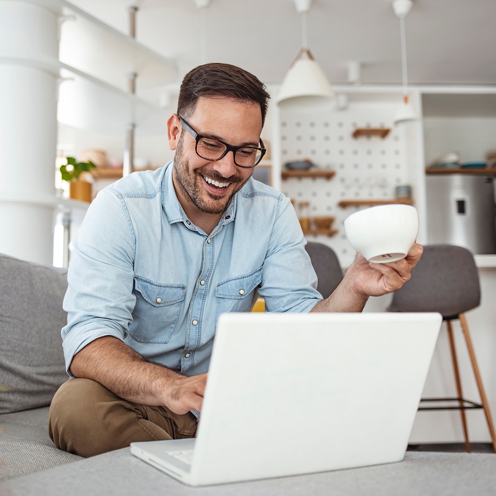 https://www.terramare.agency/wp-content/uploads/2023/02/happy-man-laptop-with-coffee.jpeg